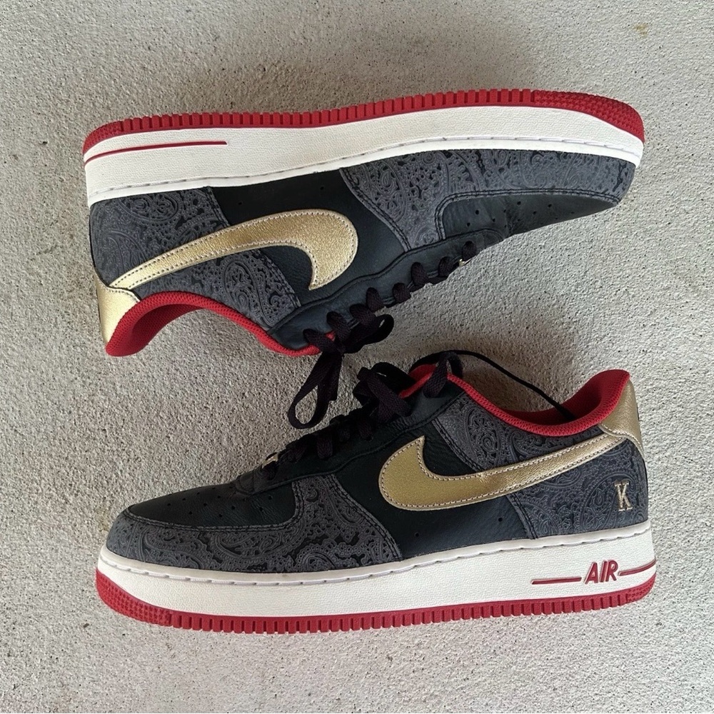 Nike Kids Black and Gold Sneakers with Red Accents